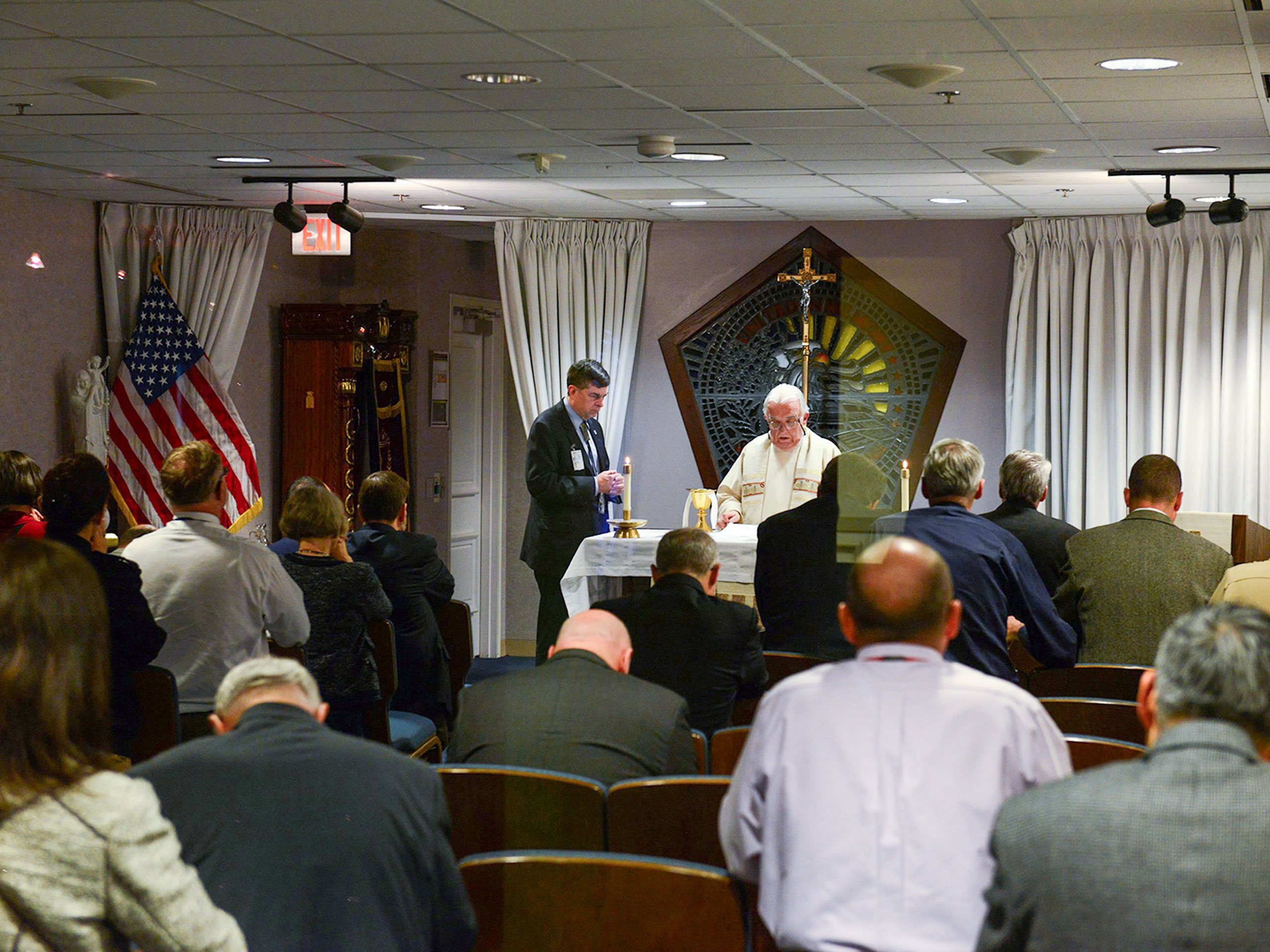 Fr. John Davis celebrates Mass, assisted by a volunteer, at the Pentagon Memorial Chapel in Arlington, Va., during the National Day of Prayer May 5, 2016. The chapel, which opened on the first anniversary of the 9/11 terrorist attack on the Pentagon, was built directly at the impact site where the hijacked plane crashed into the Pentagon. (OSV News/Courtesy of DOD/Dave Vergun)