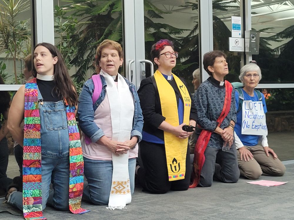 Faith leaders kneel to block an entrance to a building that houses the National Criminal Analysis and Targeting Center, Friday, Sept. 4, 2026, in Williston, Vermont. (RNS/Courtesy photo)