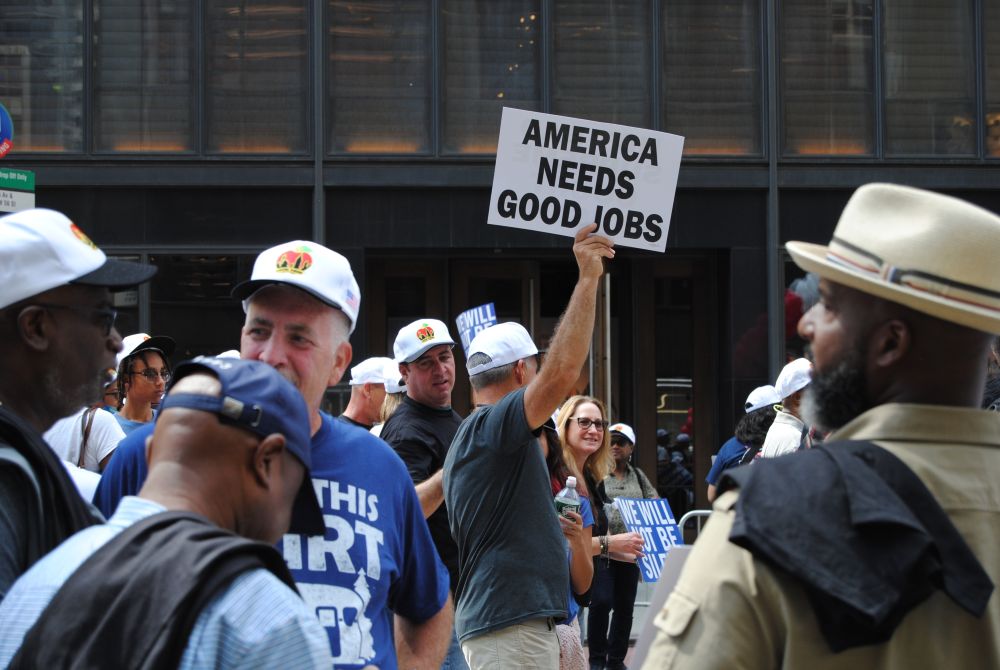 A participant holds up a sign during the Sept. 10, 2022, Labor Day parade in New York City. (Dreamstime/Erin Alexis Randolph)