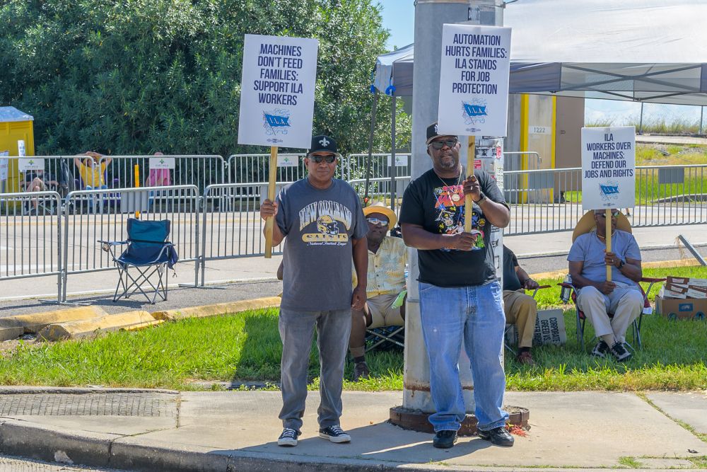 Striking International Longshoremen's Association workers stand on the picket line with signs near the entrance to Port of New Orleans Oct. 2, 2024. (Dreamstime/William Morgan)