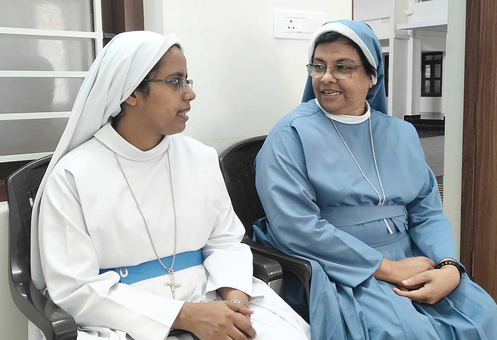 Nazareth Sr. Jaseentha Sebastian, superior general, has a discussion with Sr. Jincemol Chacko, chief therapist of the Nazareth Nature Cure Centre, at their generalate in Kunnoth, Kerala state in southwestern India. (Thomas Scaria)