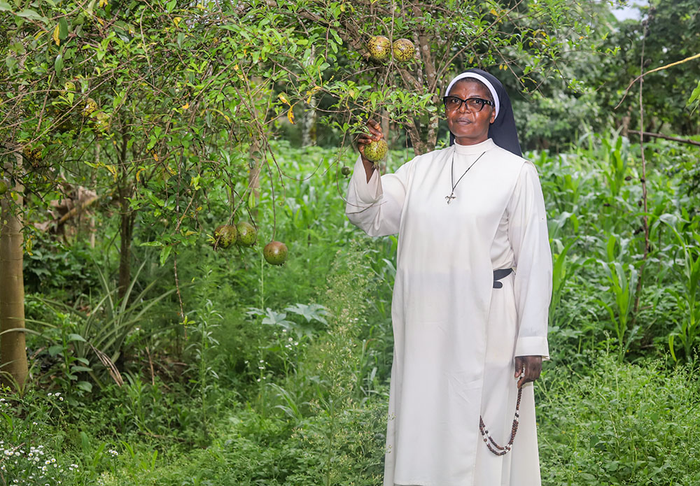 Sr. Fidelia Viban, mother general of the Dominican contemplative nuns at the Monastery of St. Dominic in Bambui, Cameroon, stands on the monastery farm. The sisters grow crops to support their community and help people in need, including families displaced by the Anglophone conflict. (GSR photo/Doreen Ajiambo)