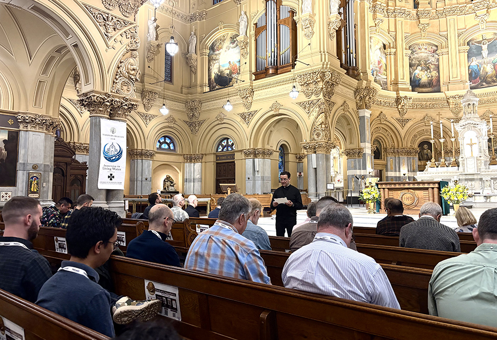 Catholic pilgrims, including LGBTQ Catholics, clergy, religious, family members and others, share a moment of reflection with St. Francis Xavier Church's pastor Jesuit Fr. Phil Florio in New York City, Sept. 26. (NCR photo/Camillo Barone)