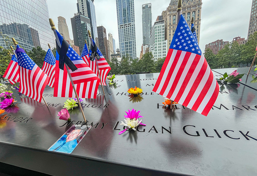Flags and flowers are placed in the inscribed names at the National September 11 Memorial in New York on Sept. 10, 2025. (AP/Donald King)