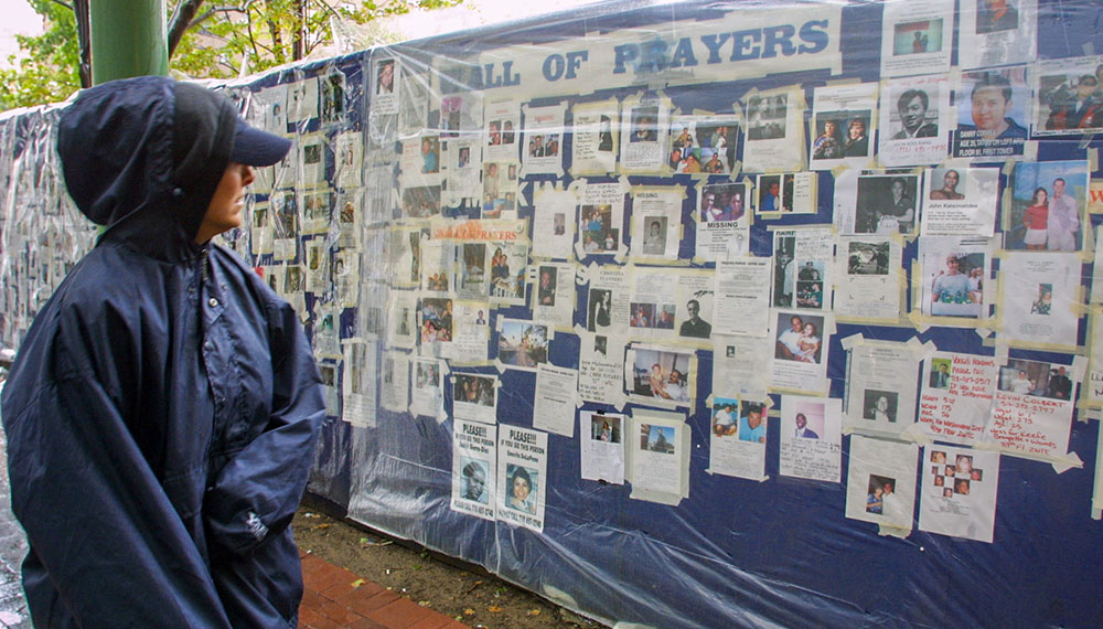 A woman looks at missing person posters of victims of the Sept. 11 terrorist attacks on the World Trade Center in New York City on Sept. 14, 2001. (AP/Robert Spencer)
