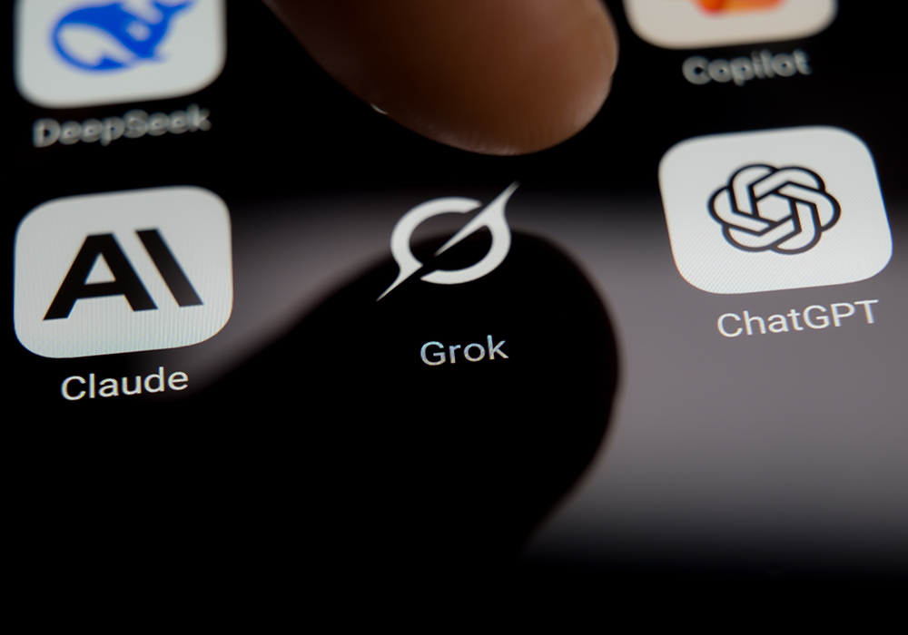 In a photo illustration, a user is about to select an AI chatbot from a smartphone screen, with DeepSeek, Grok, Claude and ChatGPT application icons displayed. (Dreamstime/Rokas Tenys)