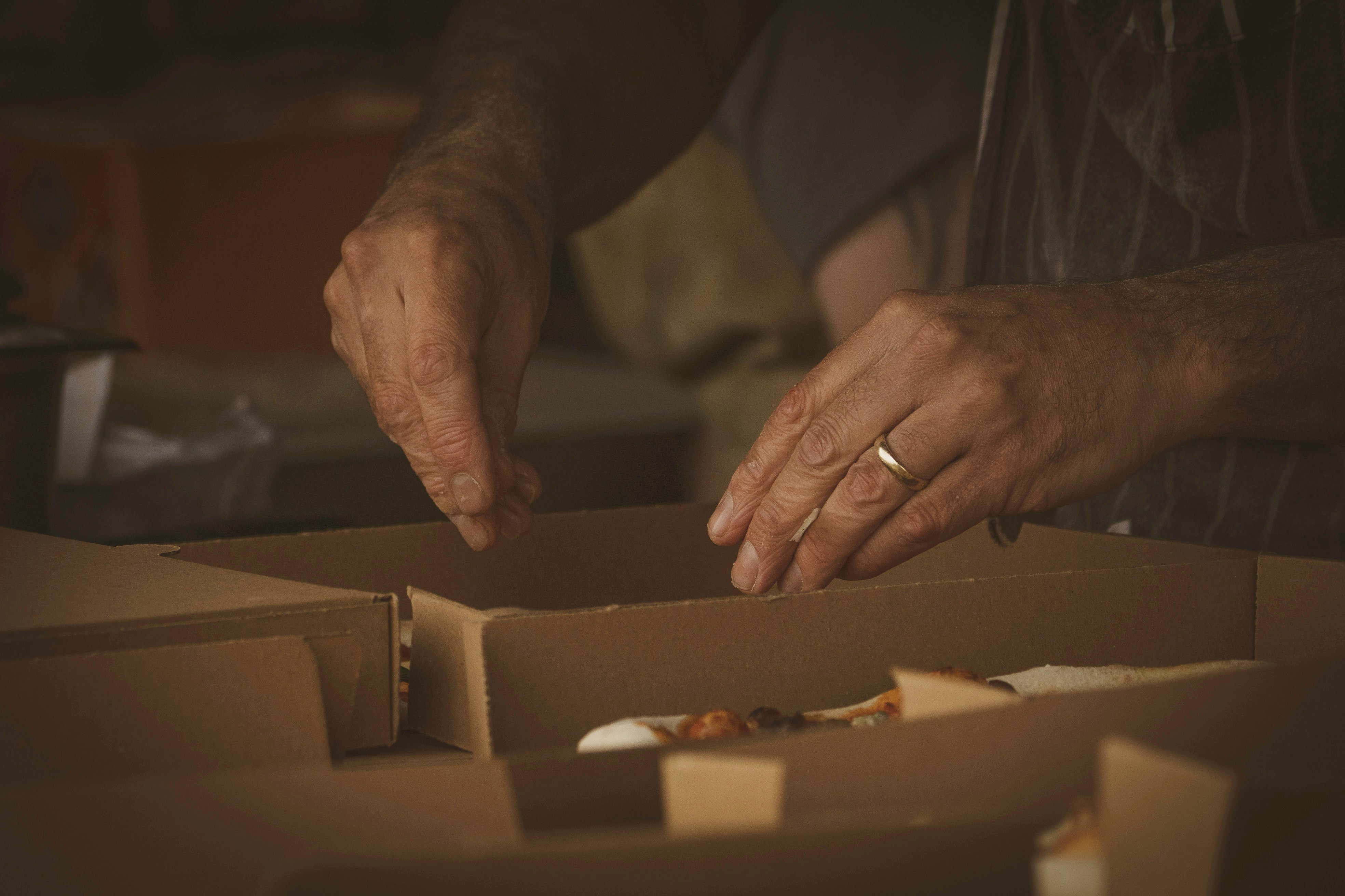 Person opening a box (Unsplash/Jonny Gios)