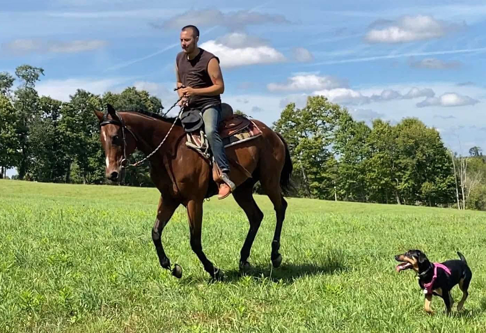 Maxwell Kuzma rides a horse on the Ohio farm where he makes his home. As this year's Season of Creation nears an end, Kuzma reflects on the invitation to pay attention to our interconnection with the natural world. (Courtesy of Maxwell Kuzma)