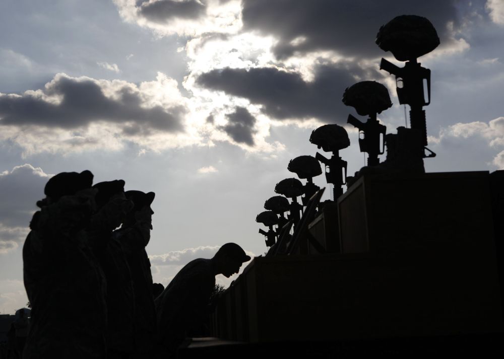 U.S. soldiers pay their respects in front of fallen soldier memorials following a memorial ceremony held at Fort Hood, Texas, Nov. 10, 2009, for victims of the Nov. 5, 2009, shooting at the Fort Hood Army post. (OSV News/Reuters/Jessica Rinaldi)