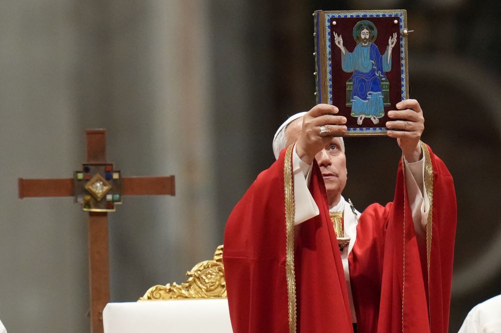 Pope Leo XIV holds up the book of the Gospel as he celebrates a mass in St. Peter's Basilica at the Vatican, Thursday, Oct.8, 2026, for the annual opening of the academic year at pontifical universities, joining Rome's 22 pontifical institutions and numerous others worldwide. (AP/Gregorio Borgia)