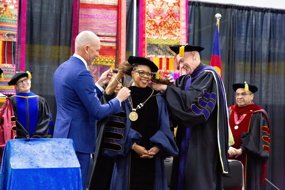 Derek Scarth, chair of Regis University's board of trustees, and Jesuit Fr. Tom Curran, superior of the Regis University Jesuit House, place the presidential medallion on Shawna Cooper Whitehead during her Sept. 18, 2026, inauguration in Denver as Regis' 29th president. (OSV News/Courtesy of Regis University)