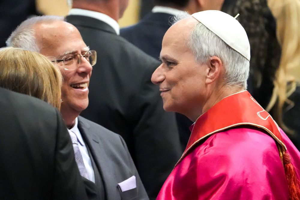 Pope Leo XIV greets his older brother, Louis Prevost, in St. Peter's Basilica following the pope's inaugural Mass at the Vatican May 18, 2025. (CNS/Lola Gomez)