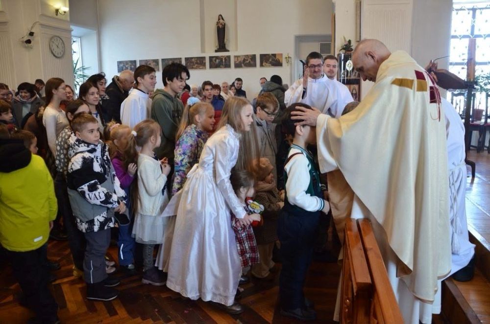 Jesuit Fr. Wojciech Ziólek blesses a child in the Siberia region Catholic parish community at the Church of Our Lady of the Rosary in Tomsk, Russia, in an undated photo. (OSV News/Courtesy of Tomsk Jesuit Parish)