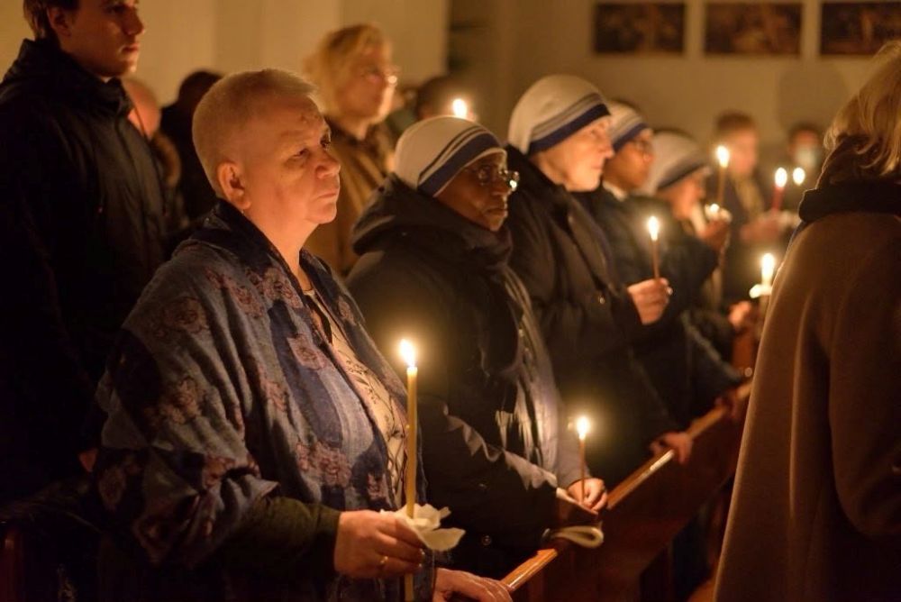 Worshippers at the Siberia region Catholic parish community hold candles at the Church of Our Lady of the Rosary in Tomsk, Russia, in an undated photo. (OSV News/Courtesy of Tomsk Jesuit Parish)