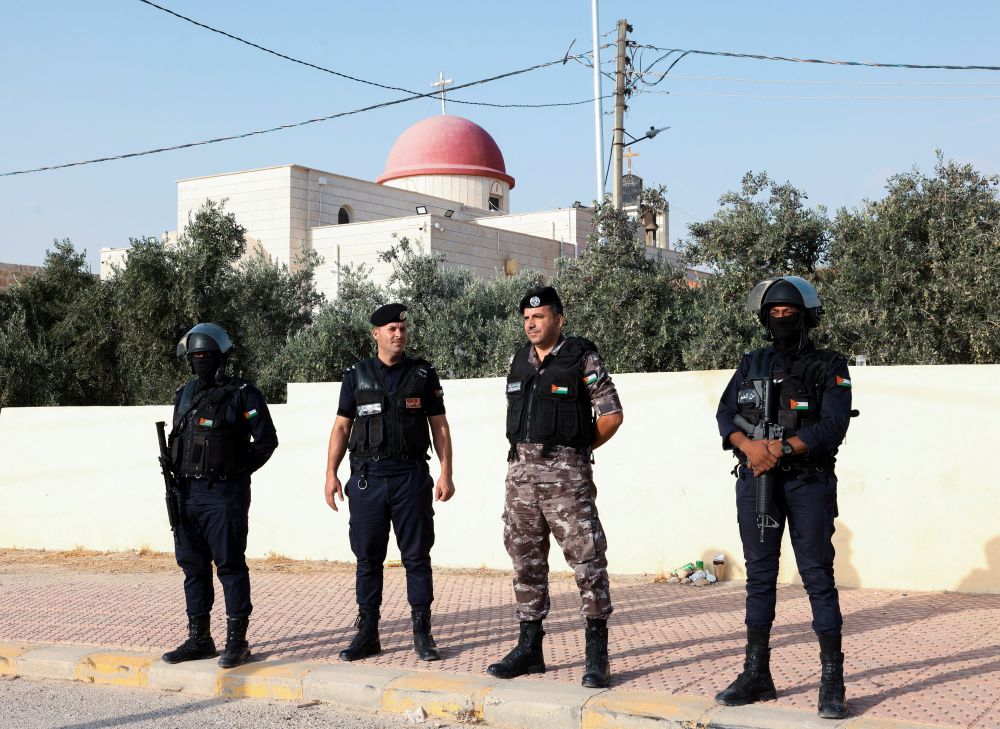 Security personnel stand outside St. George's Greek Orthodox Church, where gunmen opened fire during a funeral the previous day, in the village of Karak, Jordan, Oct. 24, 2026. (OSV News/Alaa Al Sukhni, Reuters)