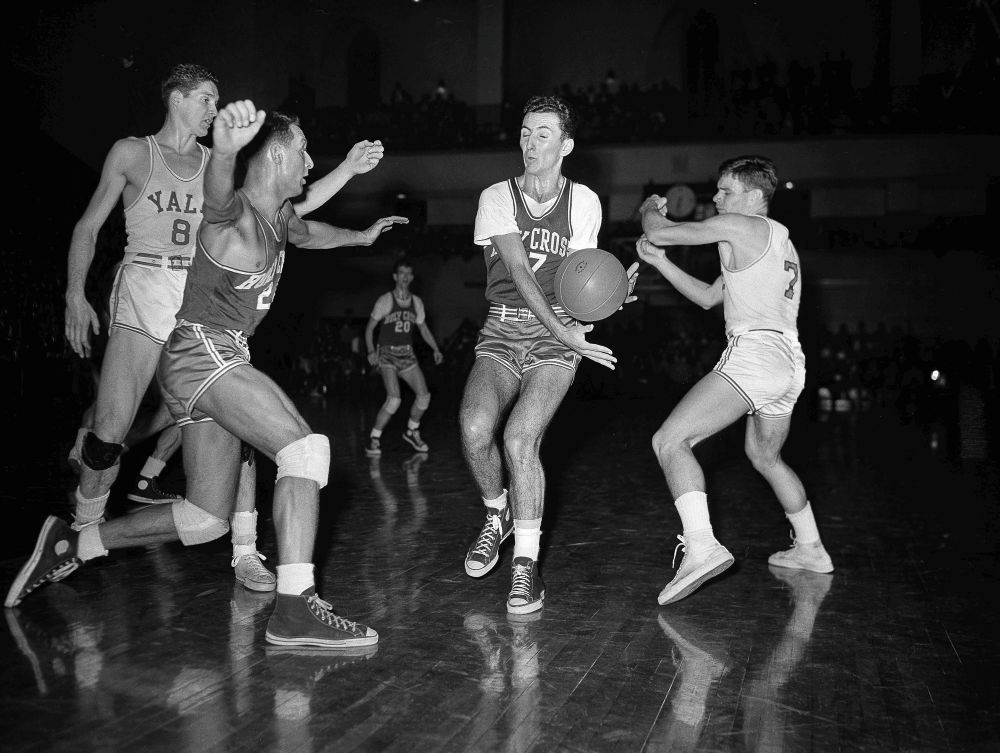Bob Cousy, Holy Cross forward, second from right, intercepts a pass during an NCAA college basketball game Feb. 19, 1949, in New Haven, Conn. (AP/File)
