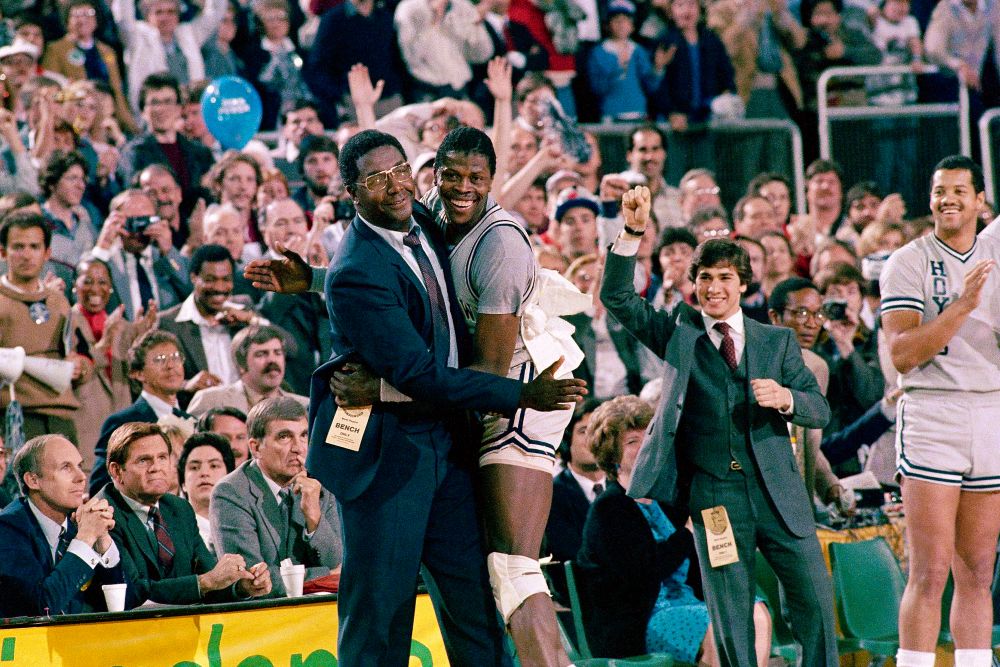 Georgetown head coach John Thompson, left, embraces most valuable player Patrick Ewing, after Georgetown defeated Houston 84-75 in Seattle on April 2, 1984. (AP/File)