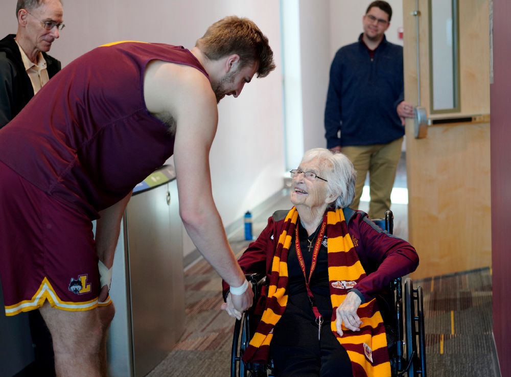 Loyola University basketball player Tom Welch shakes hands with Sr. Jean Dolores Schmidt, the team's official chaplain, before attending practice on Monday, Jan. 23, 2023, in Chicago. (AP/Jessie Wardarski)