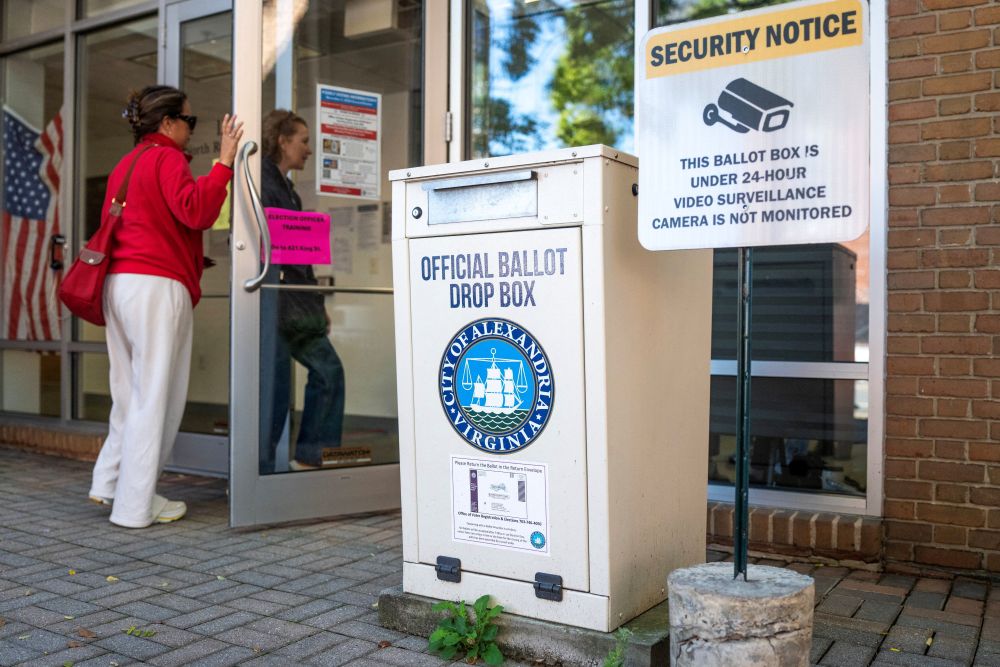 People walk past a ballot drop box during early voting at the Alexandria City Registrar Office in Virginia Oct. 7, 2026. (OSV News/Reuters/Nathan Howard)