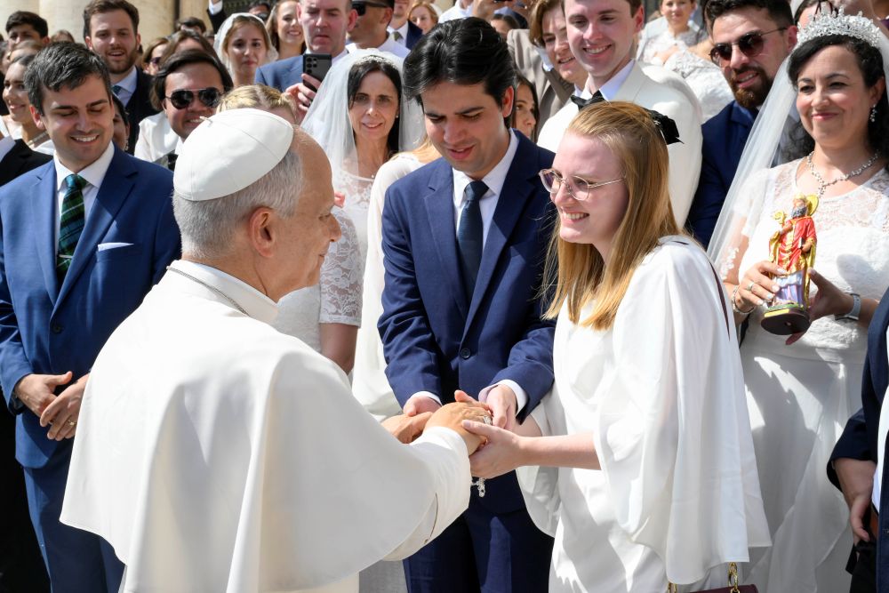 Pope Leo XIV greets a newlywed couple in St. Peter's Square at the Vatican after his weekly general audience Sept. 9, 2026. (CNS/Vatican Media)