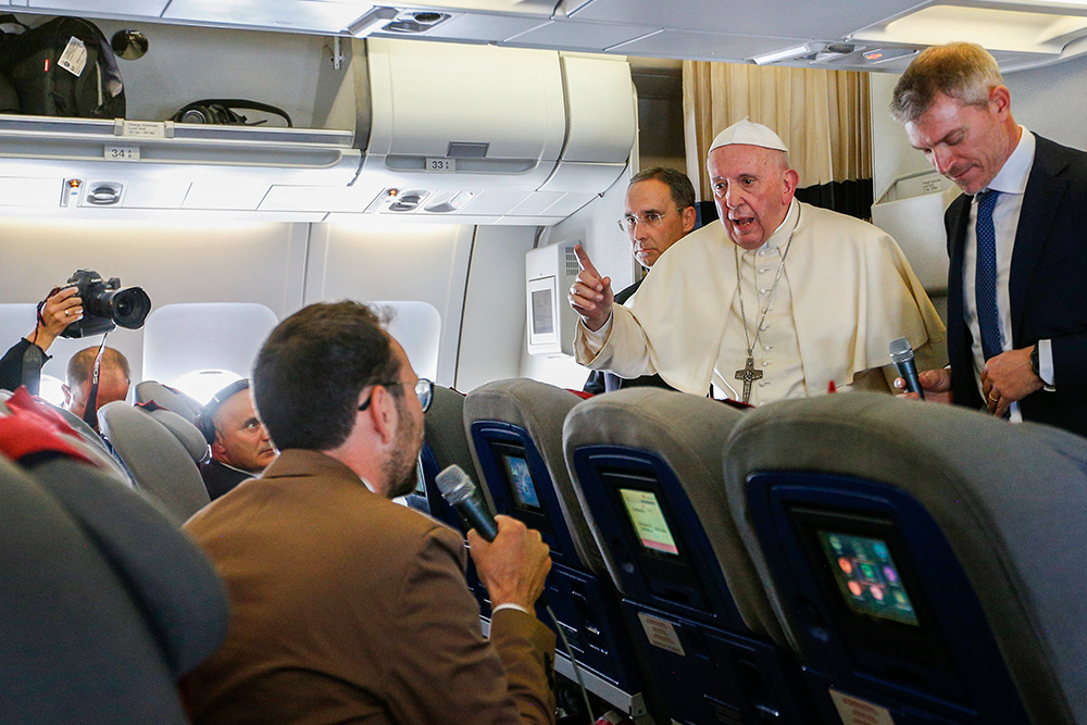 Pope Francis speaks with Jason Horowitz of The New York Times aboard the papal flight from Antananarivo, Madagascar, to Rome Sept. 10, 2019. (CNS/Paul Haring)