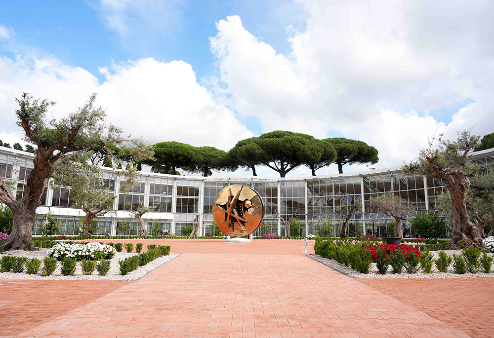 A bronze sculpture titled "Disk in the Form of a Desert Rose" by Italian artist Arnaldo Pomodoro stands at the center of the Borgo Laudato Si’ greenhouse in Castel Gandolfo, Italy, Sept. 2, 2025. (CNS/Lola Gomez)