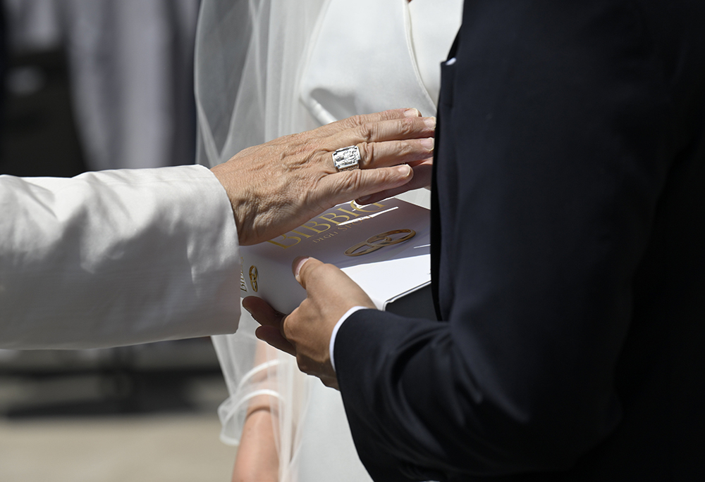 Pope Leo XIV blesses a Bible dedicated to married couples at the Vatican after his weekly general audience June 4, 2025. (CNS/Vatican Media)