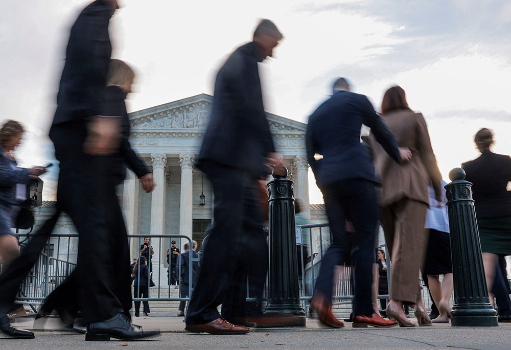 People walk in front of the U.S. Supreme Court building on the first day of the court's new term in Washington Oct. 5, 2026. (OSV News/Reuters/Jonathan Ernst)