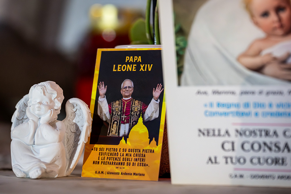 Devotional items can be seen at the foot of a statue of St. John Paul II outside of Rome's Gemelli hospital where Pope Leo XIV underwent surgery to remove a nodule in his lung Oct. 13, 2026. (CNS/Cristian Gennari)