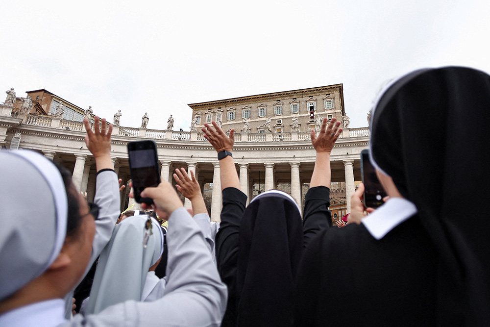 Faithful cheer as Pope Leo XIV appears in a window of the Apostolic Palace over St. Peter's Square in his first public event since his cancer surgery, at the Vatican, Oct. 18, 2026. (OSV News/Reuters/Matteo Minnella)