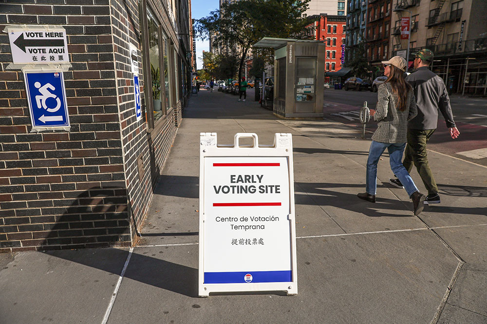 Pedestrians walk past street signage on the first day of early voting in New York, on Saturday, Oct. 24, 2026. (AP/Heather Khalifa)