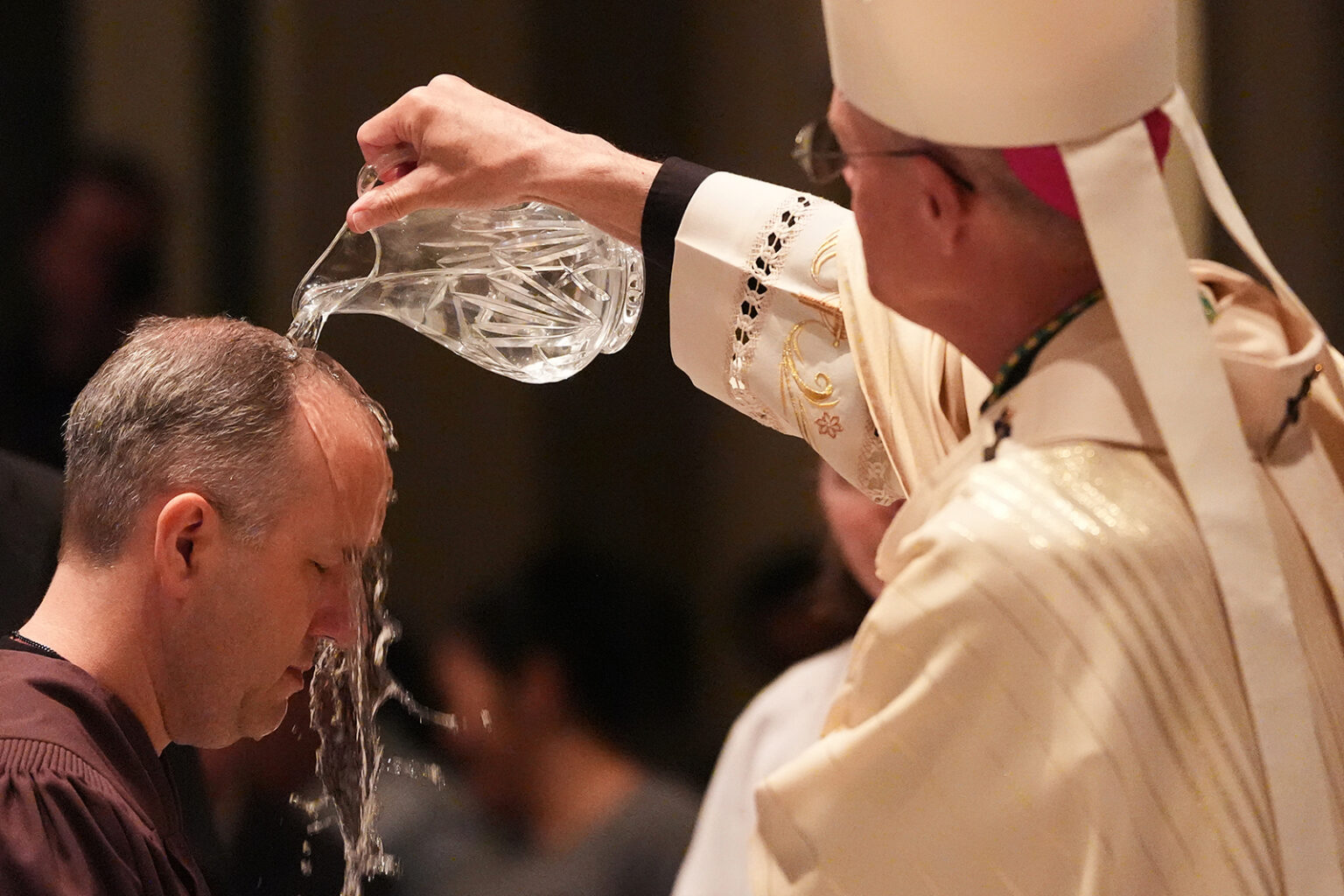 Archbishop Paul D. Etienne baptizes a candidate during an Easter Vigil service at St. James Cathedral, Saturday, April 4, 2026, in Seattle. (AP Photo/Lindsey Wasson)