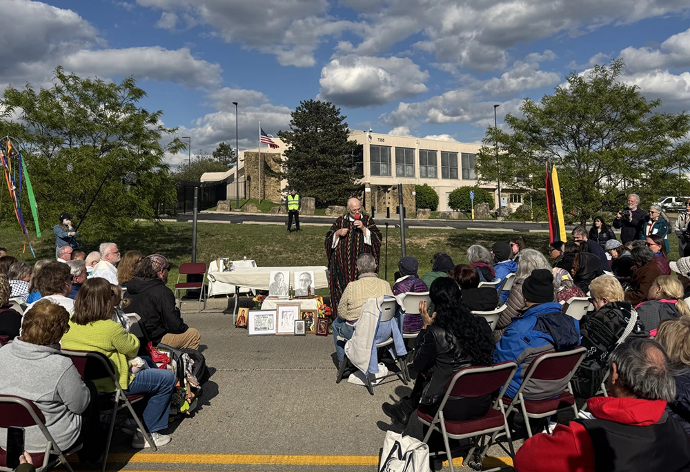 Fr. Jim Farrell celebrates a public Mass in front of the ICE processing facility in Indianapolis on May 2, 2026. (Courtesy of WFYI/Samantha Horton)