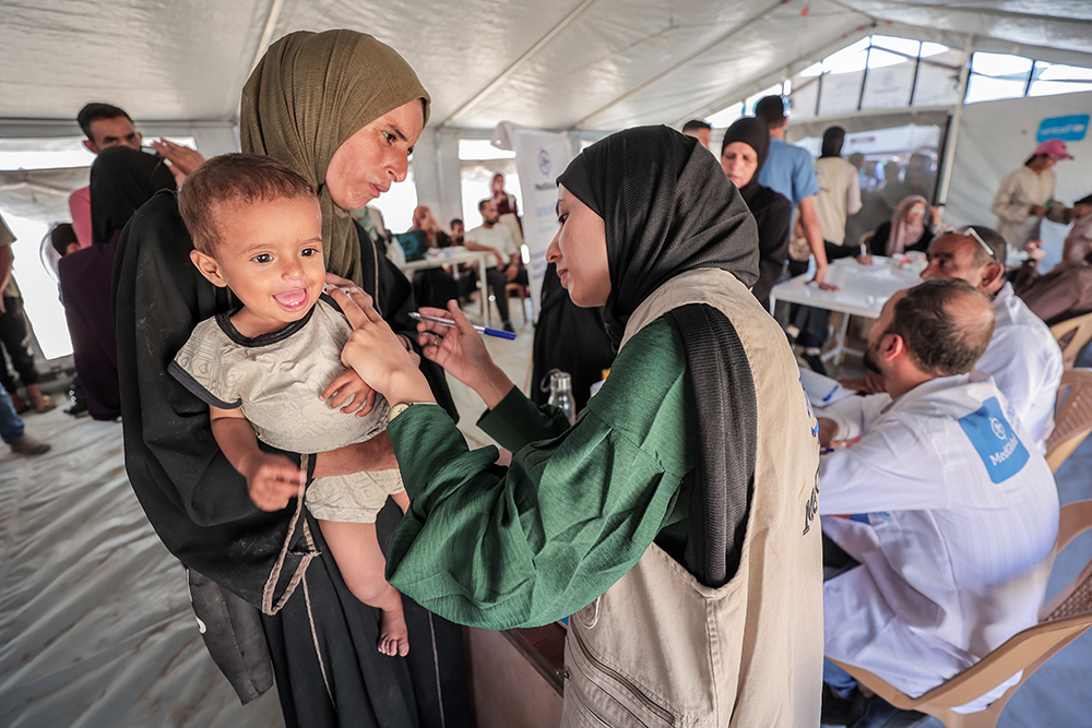 A child is screened for malnutrition in a camp in Gaza, where MedGlobal has nutrition outpatient clinics, October 2025. (Courtesy of MedGlobal)