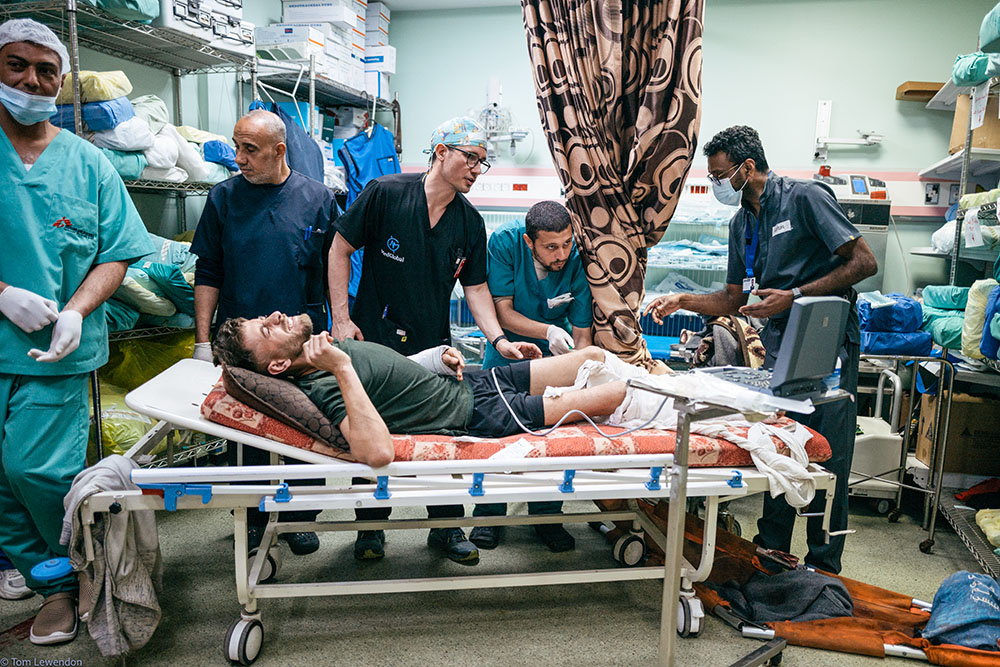 MedGlobal volunteer Dr. Jonathan Mathers assists local doctors in treating an injured patient at Al-Aqsa Hospital in Gaza, March 2024. (Courtesy of MedGlobal)