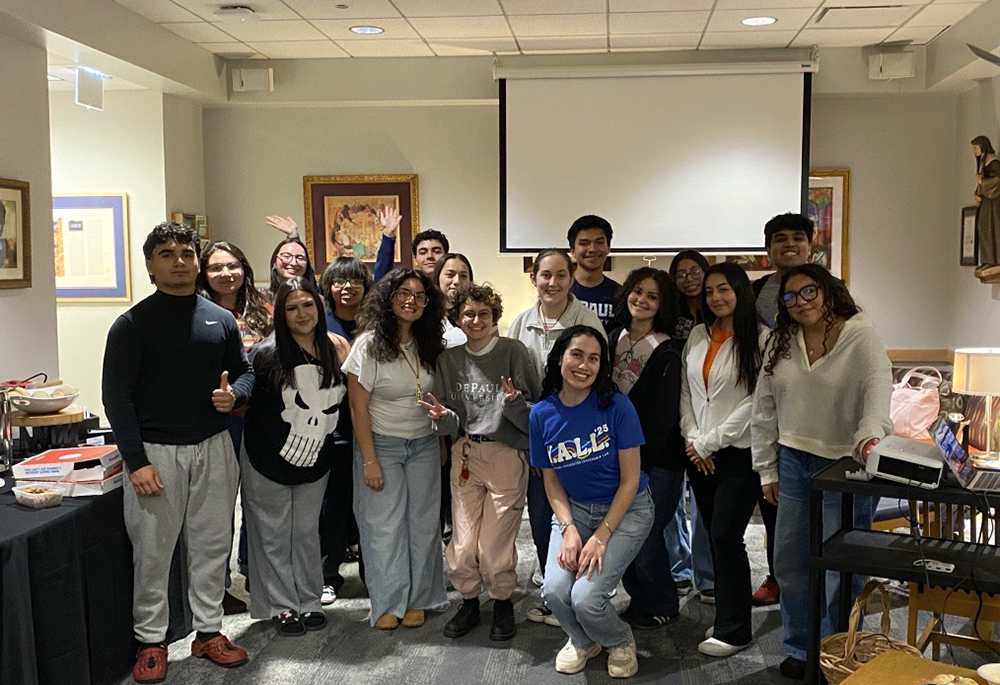 Leslie Gracia, fourth from right, kneeling, and DePaul University students in Chicago pose at a ballot research party in October 2026. (Courtesy of Leslie Gracia)