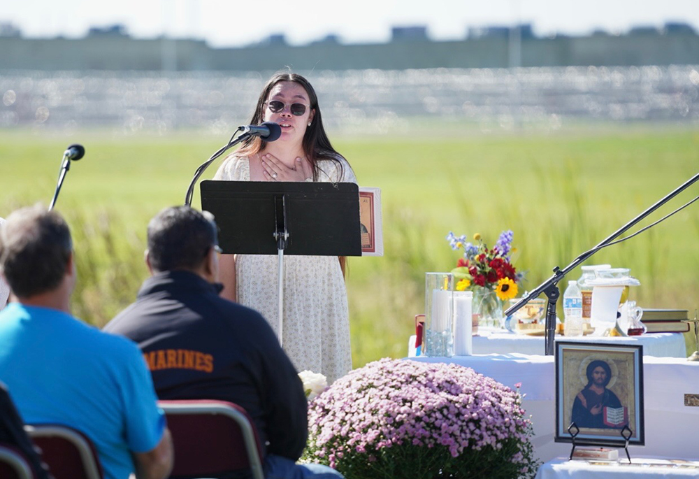 Lindsay Reyes, a 25-year-old U.S. citizen and lifelong resident of Indiana, delivers an opening witness at the Mass at Miami Correctional Facility. husband, a legal permanent resident for more than 30 years, has been in ICE detention for seven months. (Courtesy of Allison Mayer)