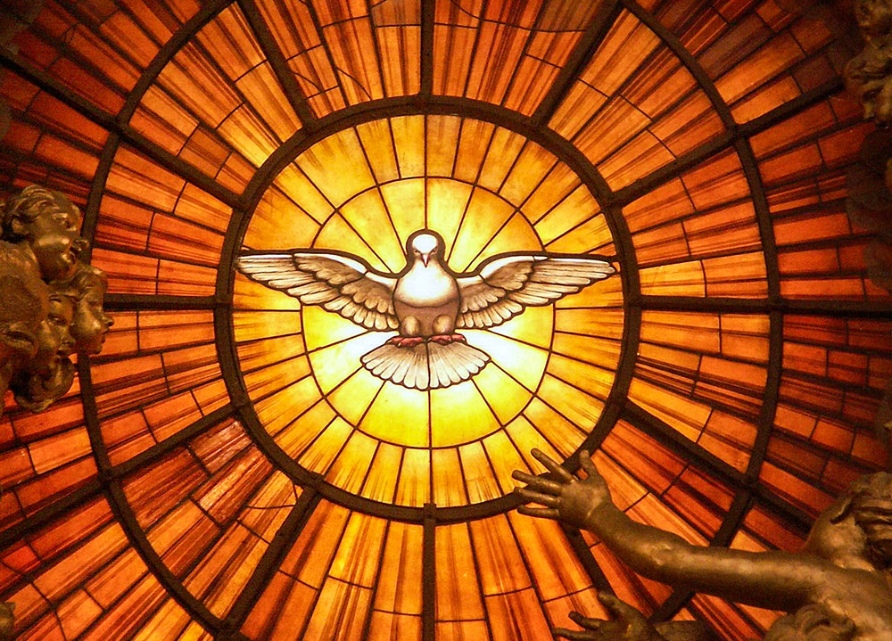 Sculptures are seen around stained glass depicting the Holy Spirit as a dove, by Gian Lorenzo Bernini circa 1660, in St. Peter's Basilica at the Vatican. (Wikimedia Commons/Dnalor 01)
