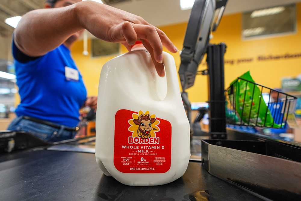 A cashier rings up a gallon of milk at a grocery store in Dallas April 15, 2026. (AP/LM Otero)