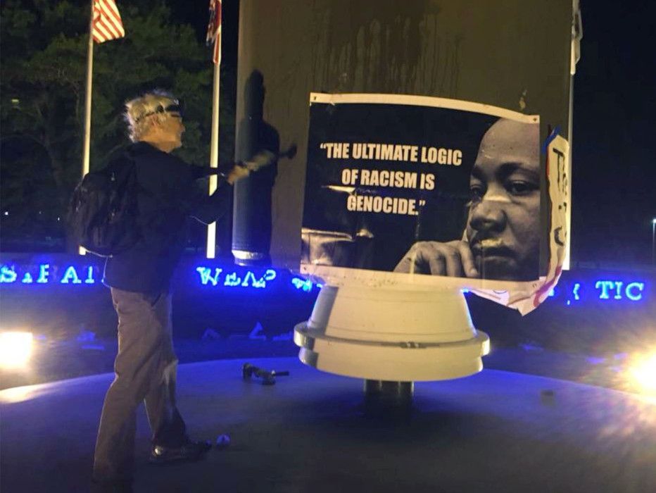 Patrick O'Neill hammers a monument to nuclear war at Kings Bay Naval Submarine Base in April 2018. He was sentenced to 14 months in federal prison after being convicted on several charges.