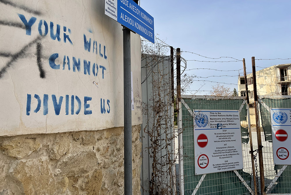 "Your Wall Cannot Divide Us" reads graffiti outside of the UN buffer zone of Nicosia. (NCR/Christopher White) "Your Wall Cannot Divide Us" reads graffiti outside of the UN buffer zone of Nicosia. (NCR/Christopher White)