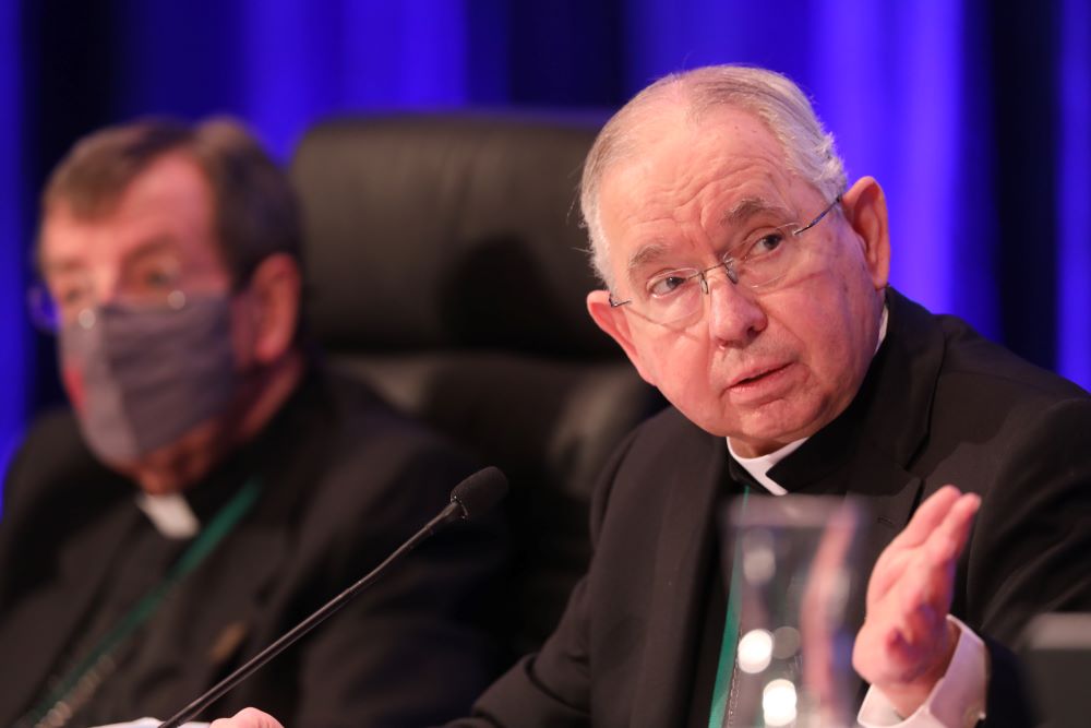 Archbishop José H. Gomez of Los Angeles, president of the U.S. Conference of Catholic Bishops, gestures during a Nov. 17, 2021, session of the bishops' fall general assembly in Baltimore. At his left is Detroit Archbishop Allen H. Vigneron. 