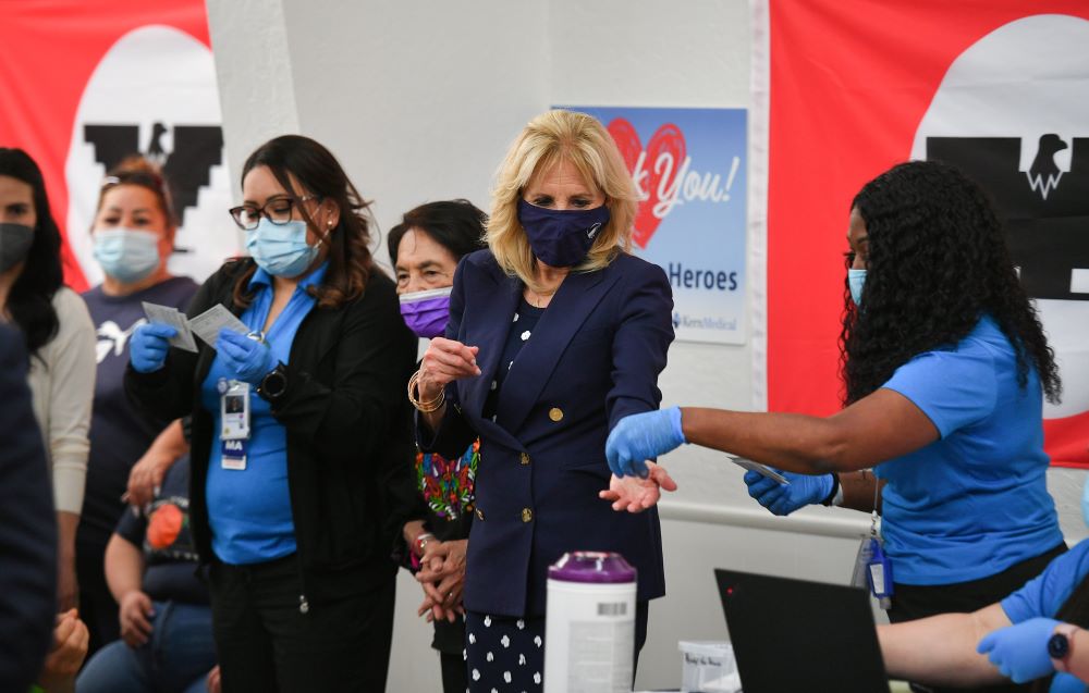 Labor leader and civil rights activist Dolores Huerta, with purple mask, stands next to first lady Jill Biden as she helps volunteers at a COVID-19 vaccination site at The Forty Acres in Delano, California, March 31, 2021. (CNS/pool via Reuters/Mandel Nga