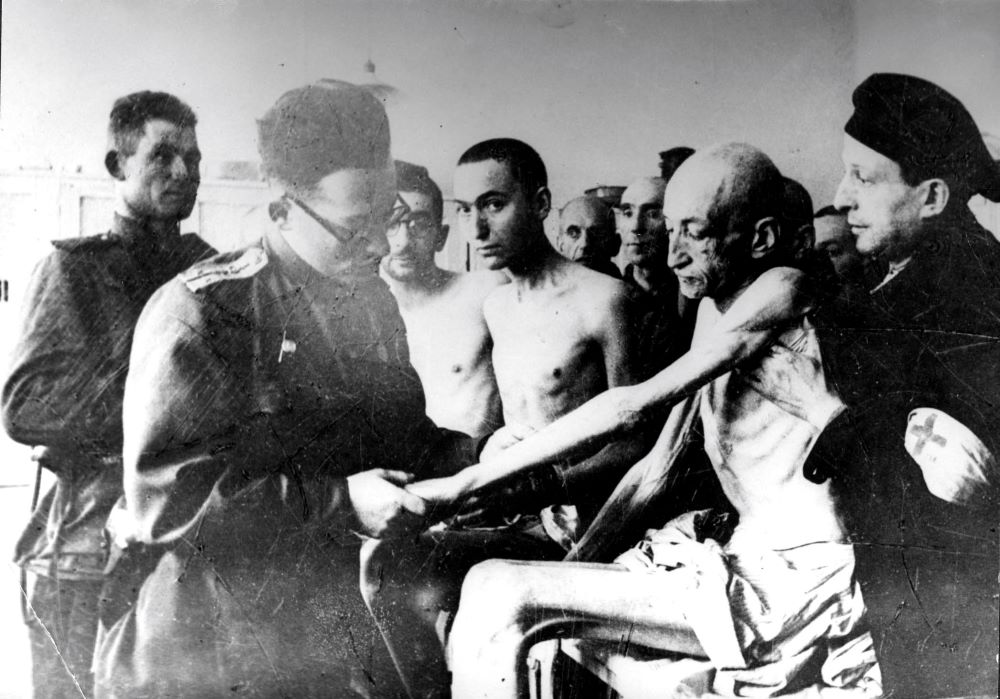 A Russian military doctor examines Holocaust survivors after the liberation of the Nazi death camp Auschwitz-Birkenau in 1945 in Oswiecim, Poland. (CNS/Reuters/Yad Vashem Archives)