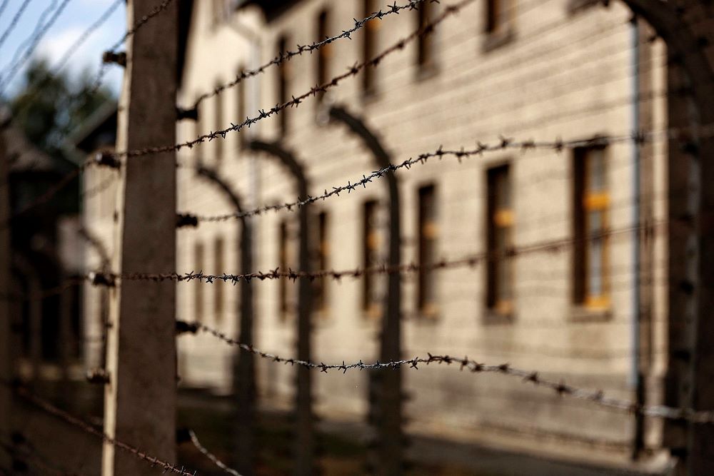 Lines of barbed-wire fencing enclose the Auschwitz-Birkenau Nazi death camp in Oswiecim, Poland, in this Sept. 4, 2015, file photo. Adolf Hitler and Nazi Germany killed 6 million Jews during World War II. (CNS/Nancy Wiechec)