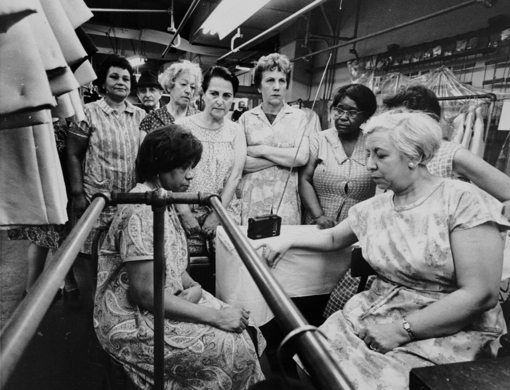 Garment workers listen to the funeral service for the Rev. Martin Luther King Jr. on a portable radio on April 8, 1968. (Flickr/Kheel Center, Cornell University)