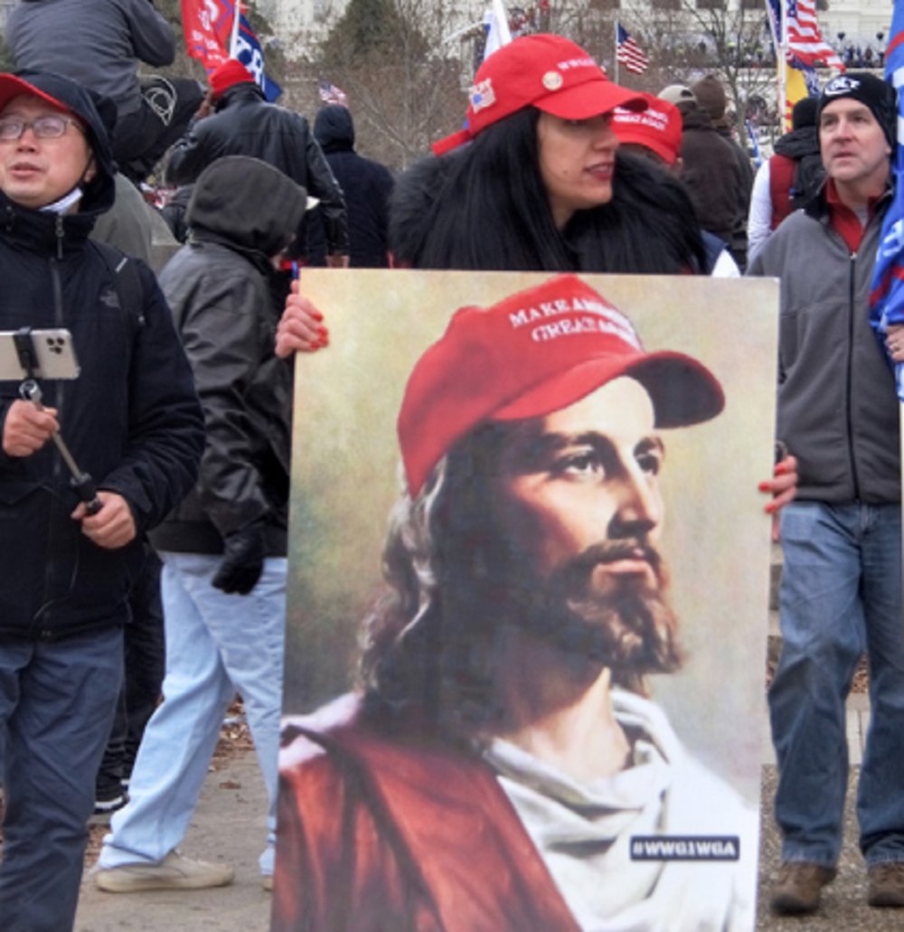 White #MAGA QAnon Jesus carried during the Jan. 6 invasion of the Capitol  (RNS/Flickr/Tyler Merbler) 