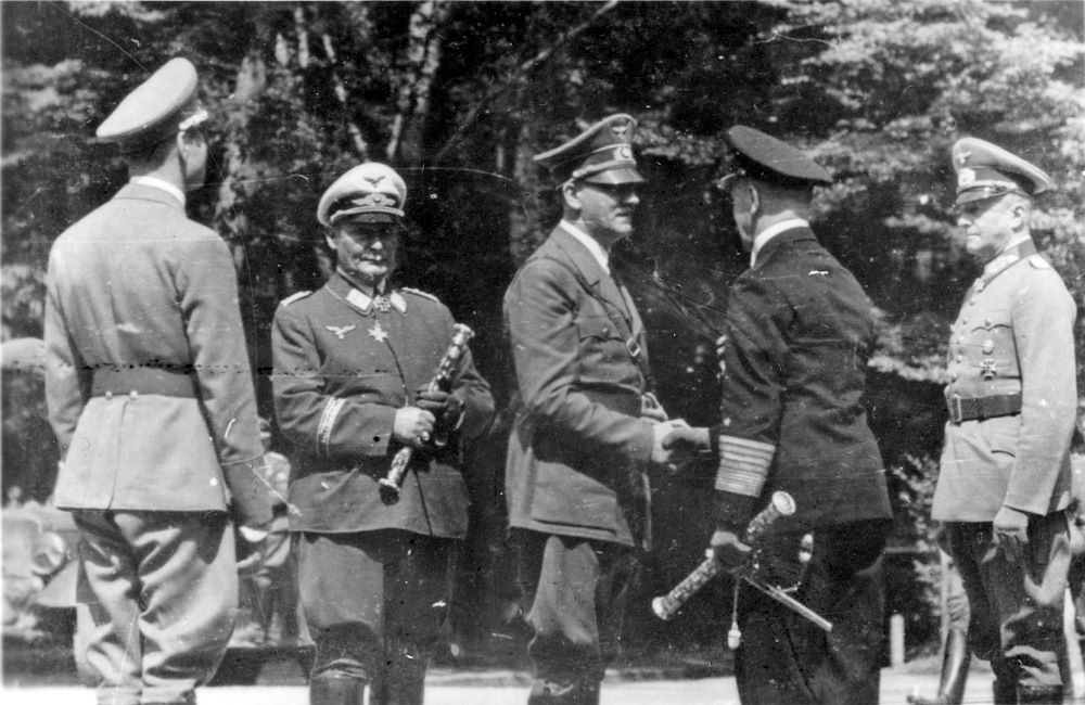 A historical photograph shows Adolf Hitler, center, greeting an officer in the French village of Compiegne June 22, 1940, after France surrendered to Nazi Germany. (CNS/Reuters/Patrick Kovacs)
