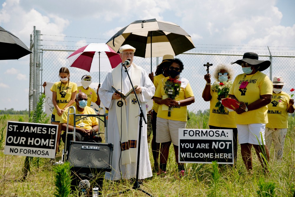 Fr. Vincent Dufresne prays at the Formosa site during a 2020 Juneteenth commemoration hosted by Rise St. James. (Courtesy of Louisiana Bucket Brigade/Bron Moyi)