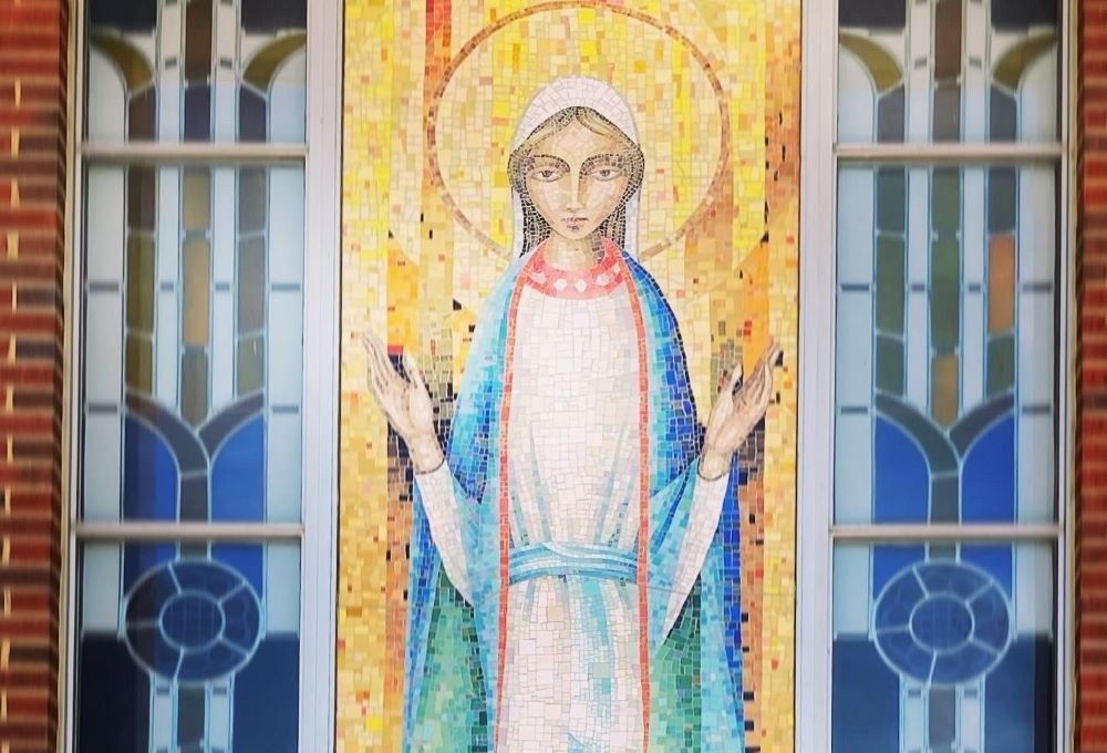 A large mosaic of Our Lady on the exterior of Notre Dame Parish in Michigan City, Indiana, greets riders at the end of the 100-kilometer Pat Mac Pack Ride fundraising ride to benefit those with pediatric brain cancer. (Mark Piper)